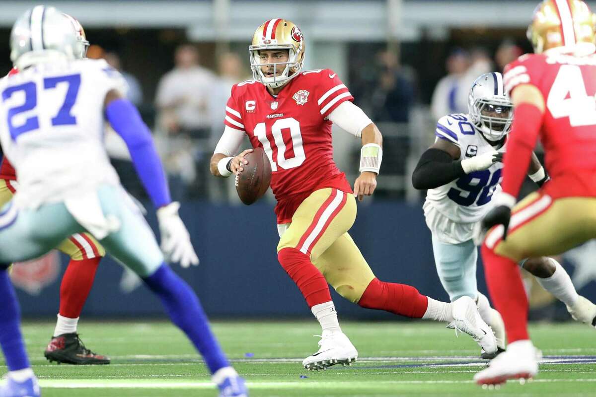 San Francisco 49ers' Jimmy Garoppolo scrambles in 2nd quarter against Dallas Cowboys during NFL NFC Wild Card Playoff game at AT&T Stadium in Arlington, Texas on Sunday, January 16, 2022.