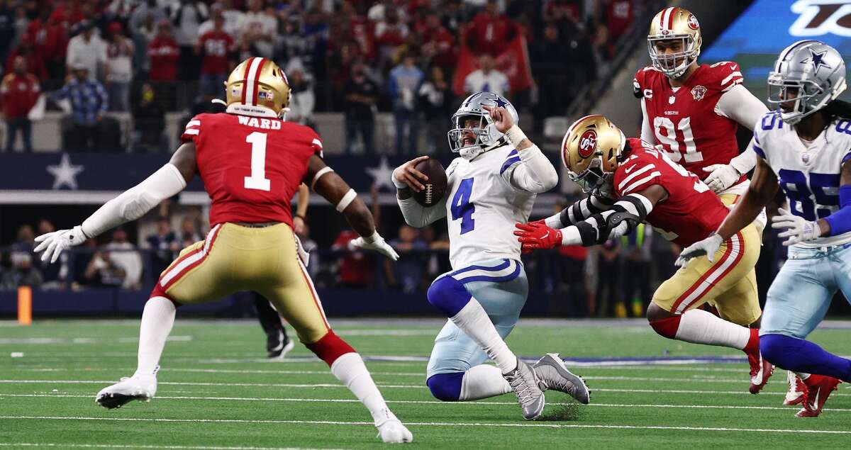 Dak Prescott #4 of the Dallas Cowboys scrambles with the ball on the last play of the game against the San Francisco 49ers during the fourth quarter in the NFC Wild Card Playoff game at AT&T Stadium on January 16, 2022 in Arlington, Texas. (Photo by Tom Pennington/Getty Images)