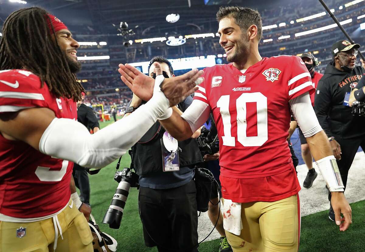 San Francisco 49ers' Jimmy Garoppolo and Fred Warner celebrate 23-17 win over Dallas Cowboys in NFL NFC Wild Card Playoff game at AT&T Stadium in Arlington, Texas on Sunday, January 16, 2022.