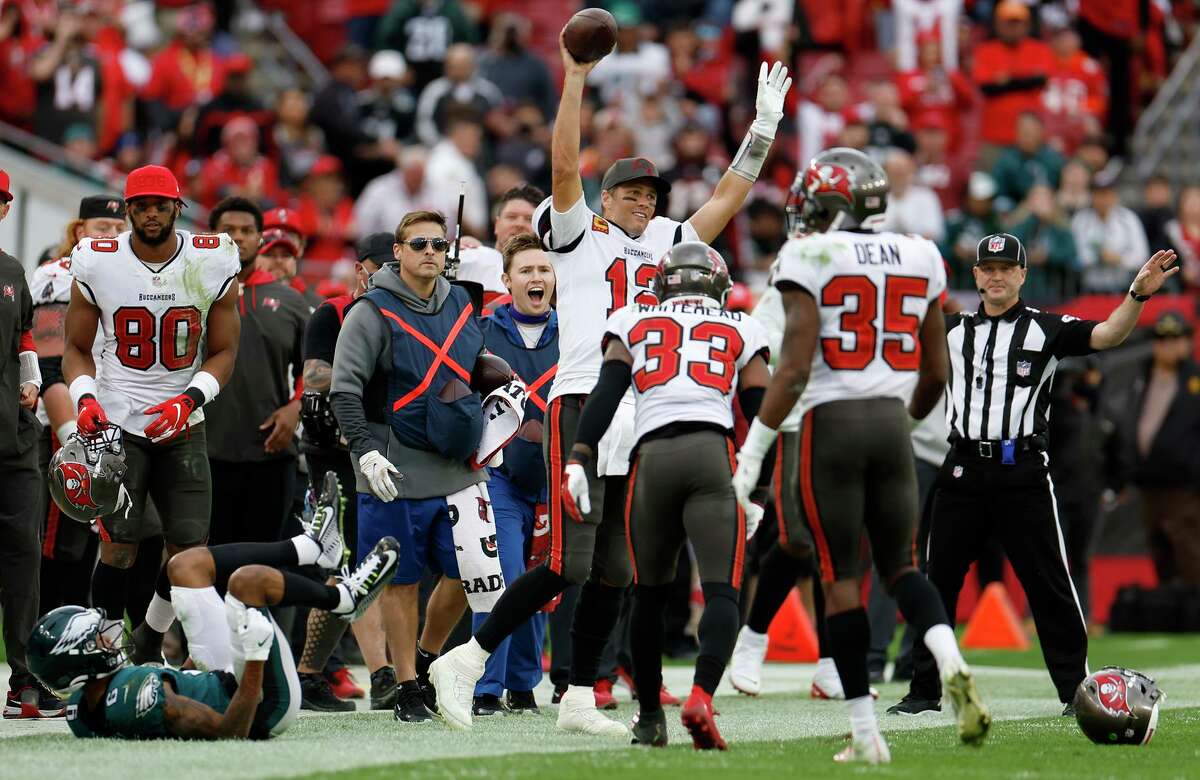 Tom Brady of the Tampa Bay Buccaneers raises his arms in celebration in the fourth quarter against the Philadelphia Eagles.