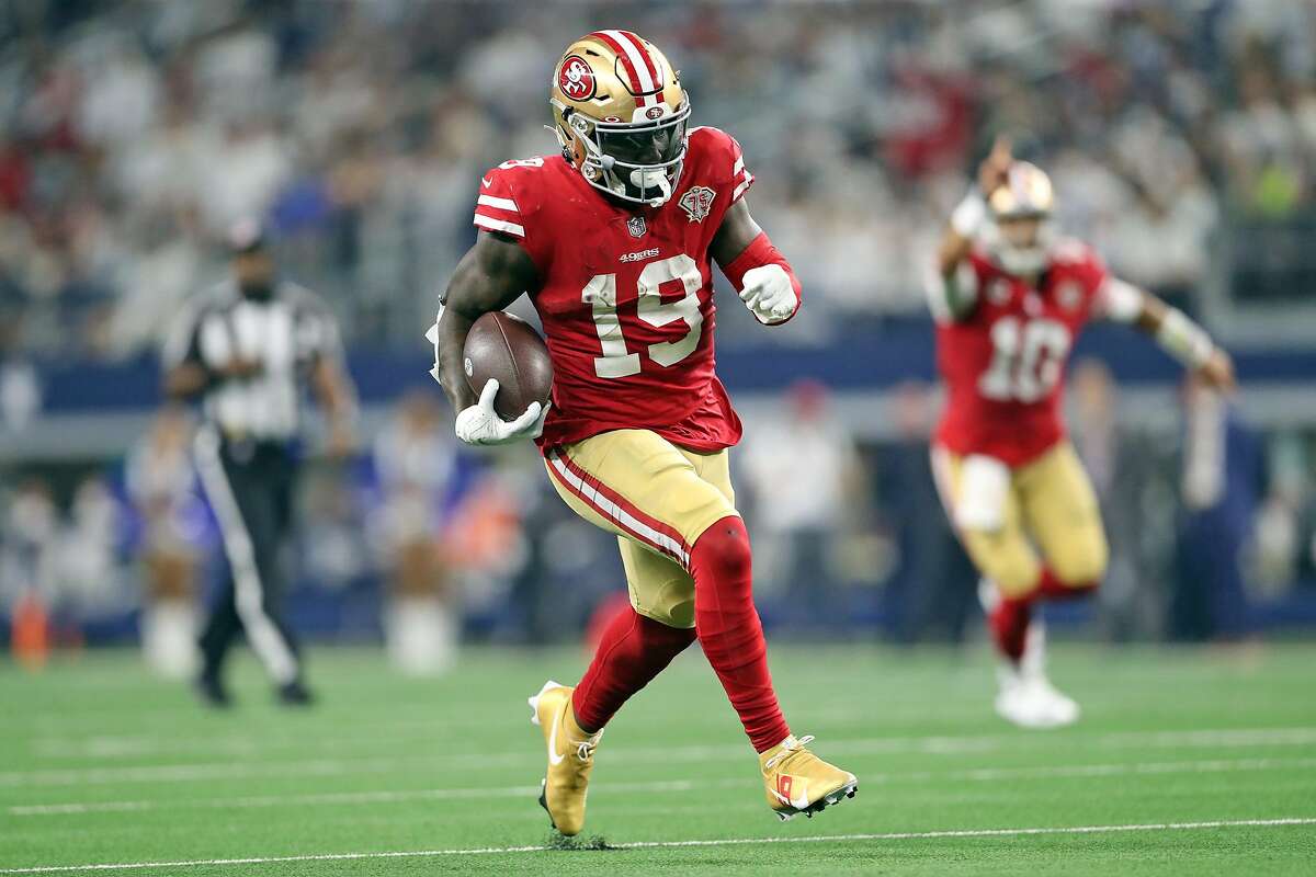 San Francisco 49ers' Deebo Samuel scores on a 26-yard rush in 3rd quarter against Dallas Cowboys during NFL NFC Wild Card Playoff game at AT&T Stadium in Arlington, Texas on Sunday, January 16, 2022.