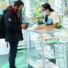 A Costumer from Connecticut buys marijuana supplies at the Weed World store on March 31, 2021, in New York. Experts say Connecticut could see a big surge in demand when it launches its recreational marijuana program this year.