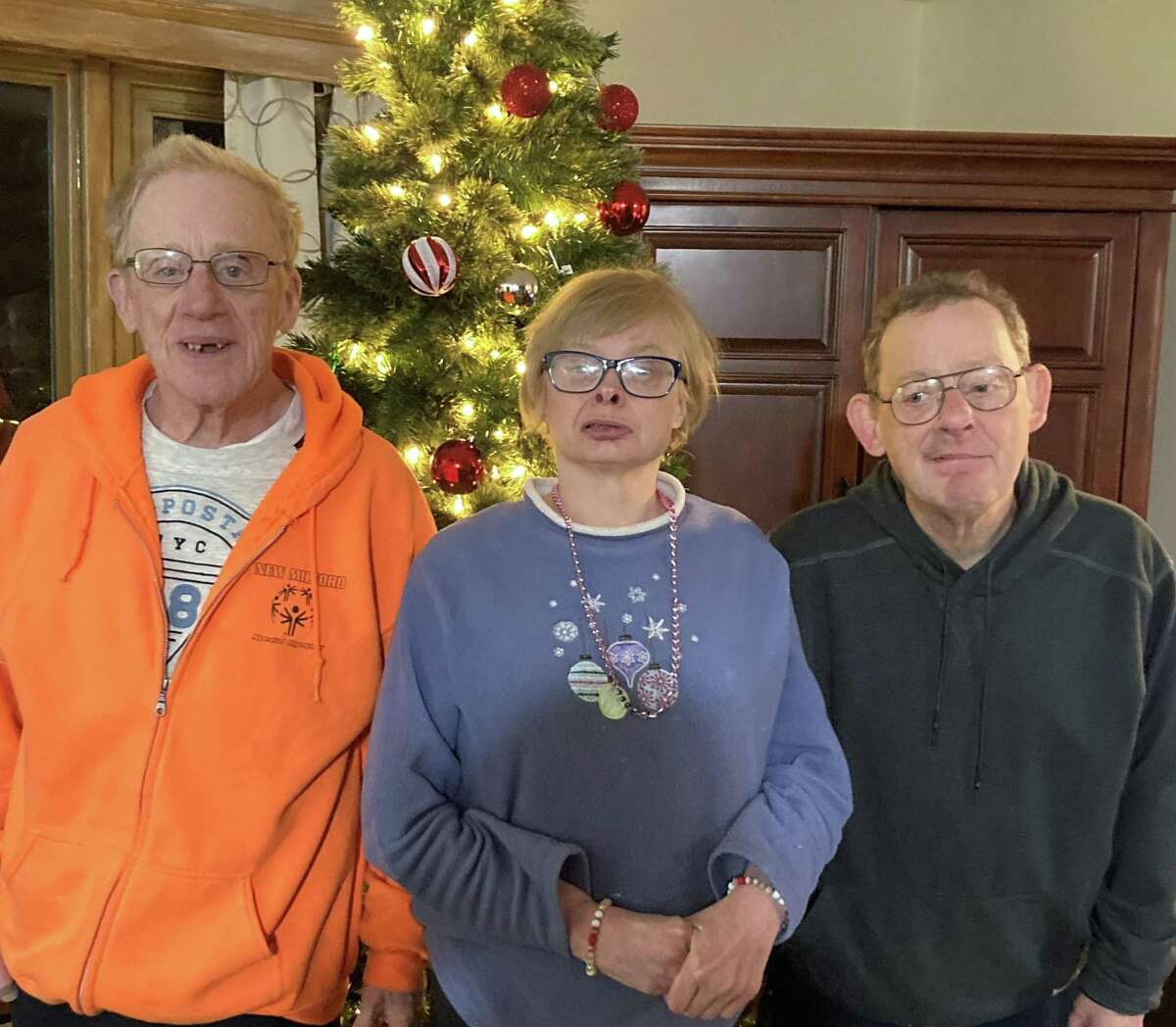 From left, Marty, Tommy, and Kathryn celebrate Christmas at the Ability Beyond home in New Milford