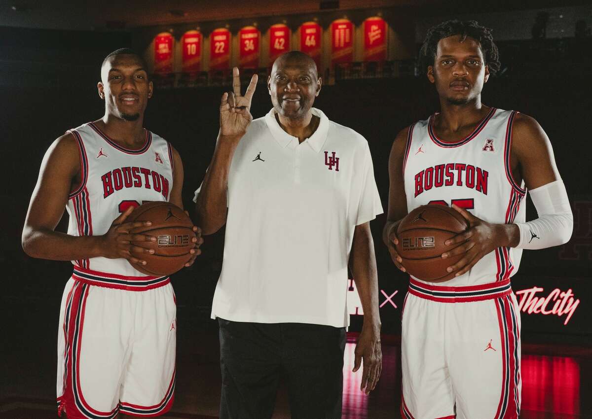 Fabian White Jr. (left) and Josh Carlton flank UH legend Elvin Hayes in the throwback uniforms the Cougars will wear Tuesday against South Florida.
