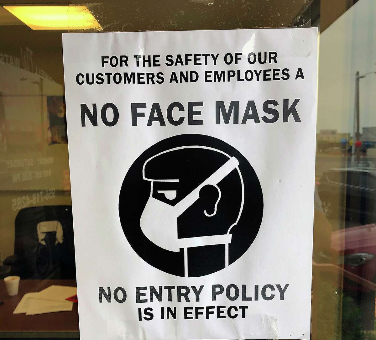FILE — With the approval by City Council of an ordinance requiring citizens to cover their mouth and nose when entering an essential business, businesses like Powell Watson Savings Center on Saunders have posted signs enforcing a “No Face Mask, No Entry Policy” for the safety of their employees and customers.