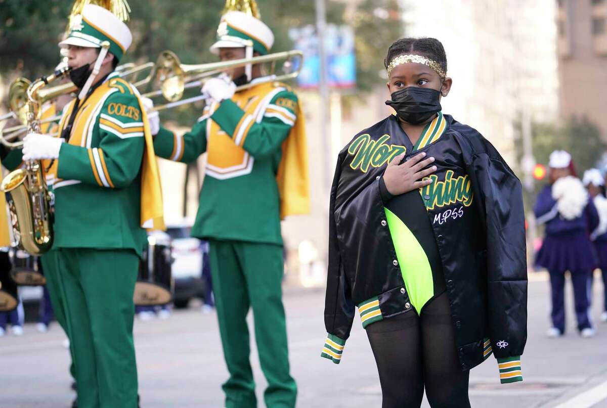Hunter Brantley, 7, tries to stay warm during the National Anthem before marching with the Worthing High School band during the 44th annual Original MLK Day Parade hosted by the City of Houston and the Black Heritage Society Monday, Jan. 17, 2022 in Houston.
