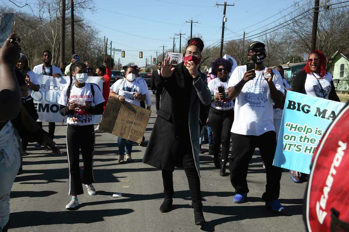 Marchers, including San Antonio City Council District member Jalen McKee-Rodriguez, center, dance to the music as they participate in the Martin Luther King Freedom March along MLK Boulevard on Monday. A small group of around 70 marched from Pittman-Sullivan Park to Martin Luther King Park. The official march, which draws hundreds of thousands, was canceled due to COVID-19. It is the second year the march has been canceled.