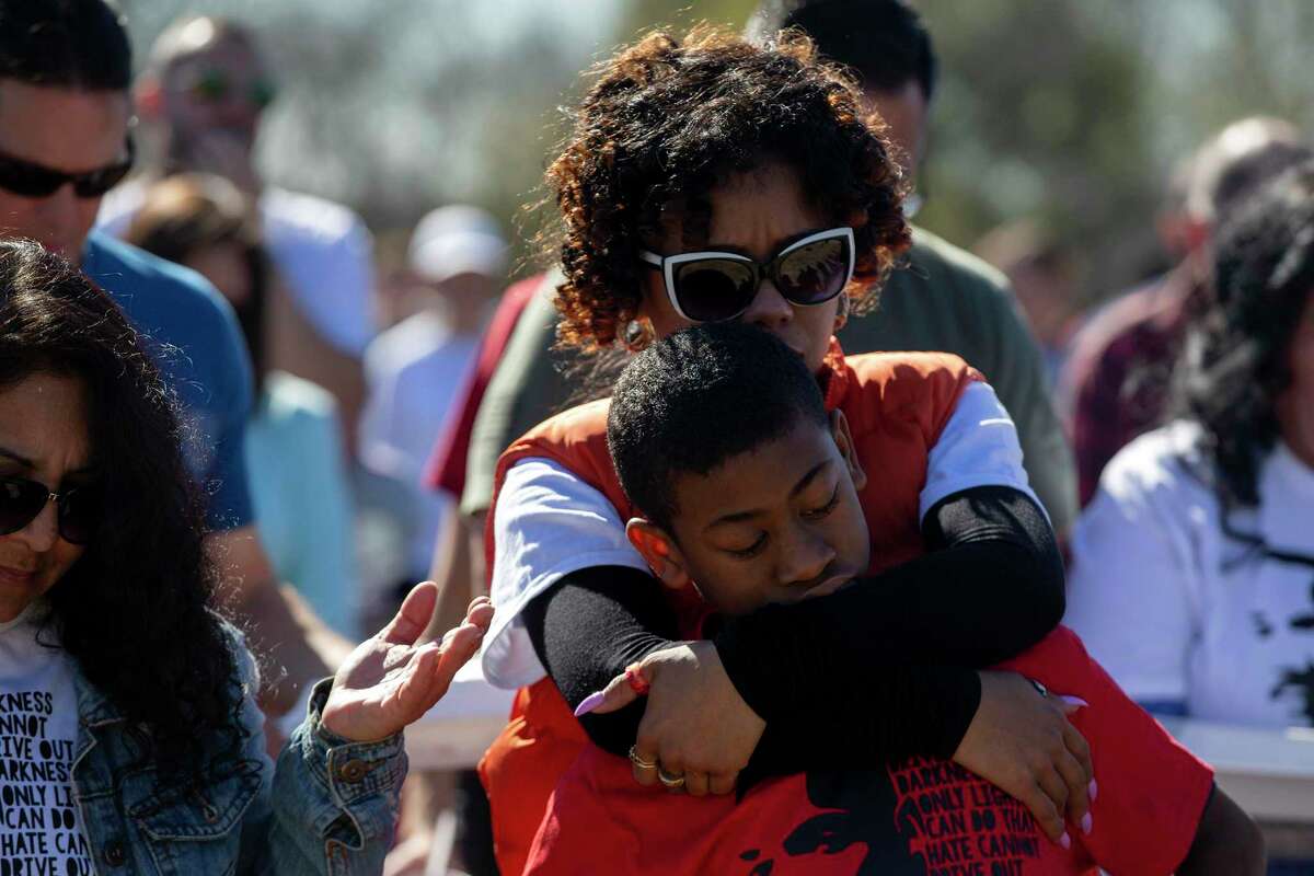 Carlisa Andrews holds her son, Josiah, during prayers after the MLK Freedom Walk. This march was organized after the city canceled their march due to COVID concerns.