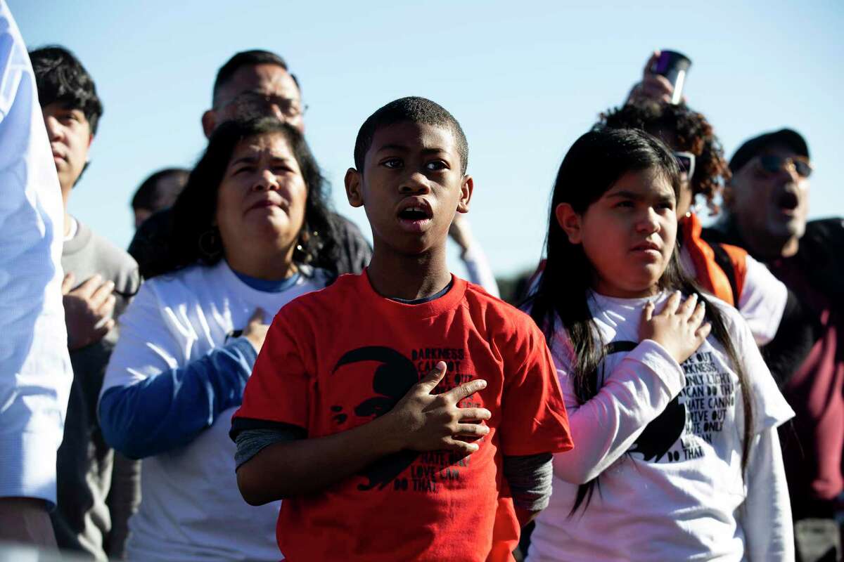 Josiah Amdrews recites the pledge of Allegiance next to his friend, Ezra Sotello ahead of the MLK Freedom Walk. This march was organized after the city canceled their march due to COVID concerns.