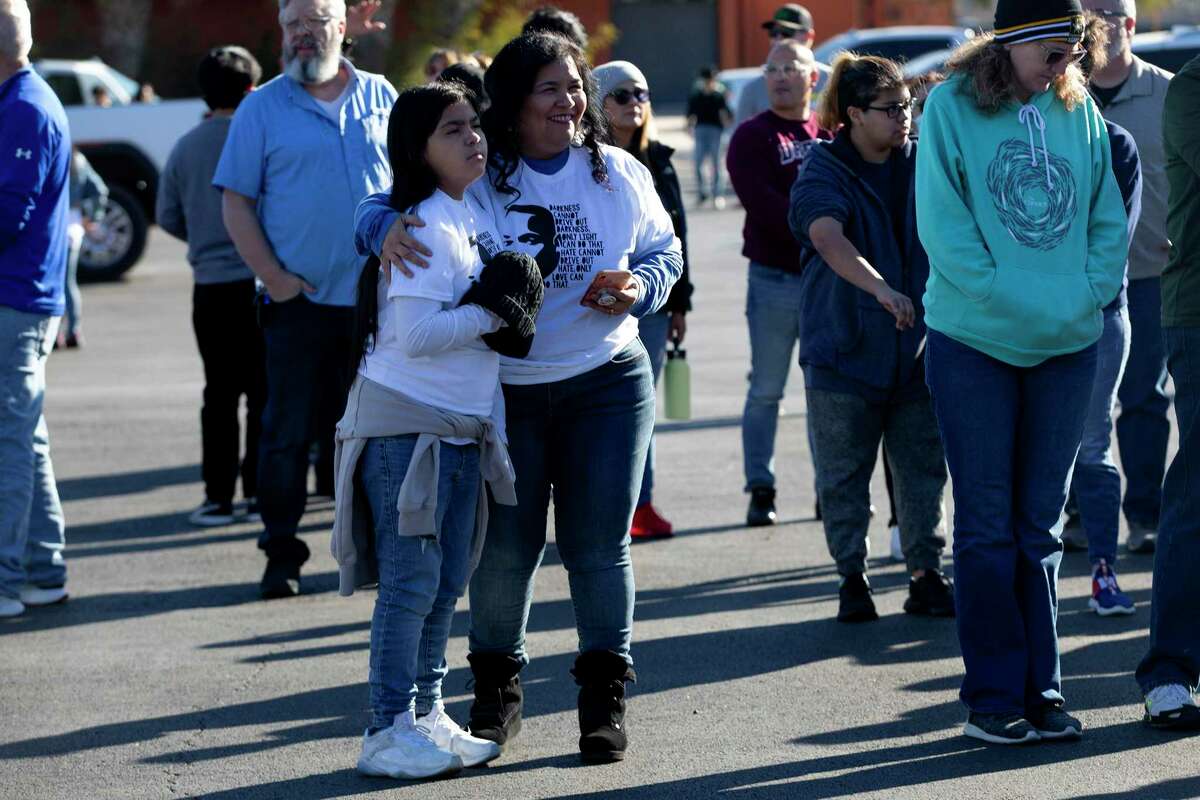 Lisa Sotello hugs her daughter, Ezra, as they wait for the MLK Freedom Walk to begin. Sotello said it was important to attend the march because “I believe in what Martin Luther King spoke. His words still resonate and now its the time for people to come together and unify.”