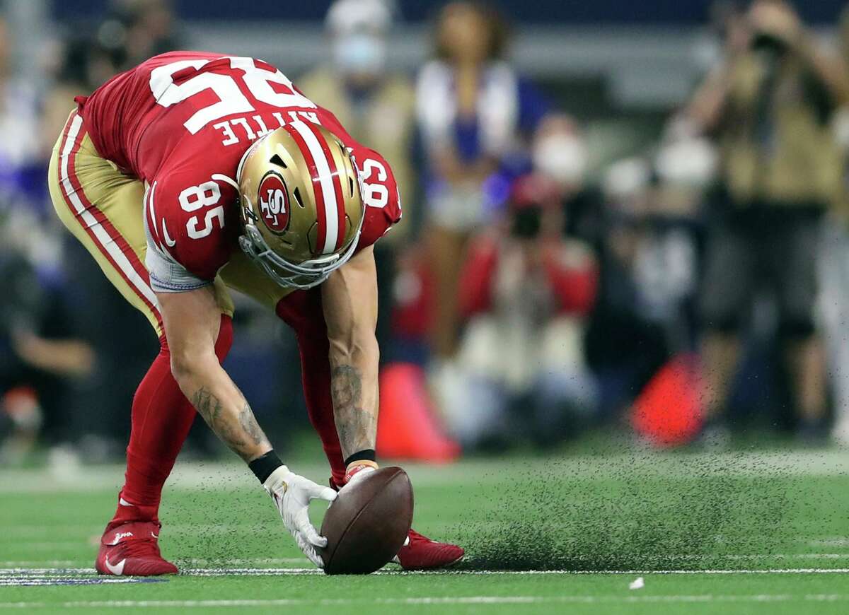 San Francisco 49ers tight end George Kittle scoops the ball off the turf during the fourth quarter of Sunday’s wild-card playoff game against the Dallas Cowboys.