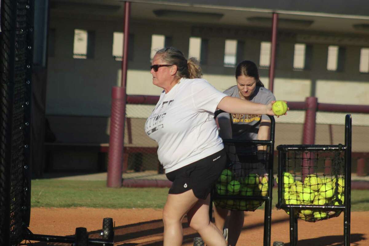 Deer Park softball head coach Amy Vidal throws batting practice to her team on the first day of practices across the state Friday.