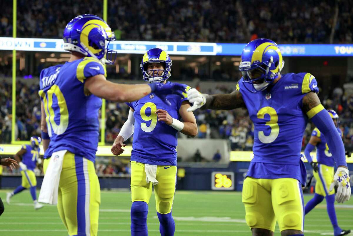INGLEWOOD, CALIFORNIA - JANUARY 17: Matthew Stafford #9 of the Los Angeles Rams celebrates his touchdown pass to Cooper Kupp #10 of the Los Angeles Rams during the third quarter against the Arizona Cardinals in the NFC Wild Card Playoff game at SoFi Stadium on January 17, 2022 in Inglewood, California. (Photo by Harry How/Getty Images)