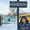 Fatima Anguiano, the CASMAN Academy Student of the Month, poses next to the sign that names the school driveway in her honor.
