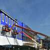On boom lifts, crews continue work on a southern facade of Darien Crossing on Thursday, Jan. 13, 2022, in Darien, Conn.