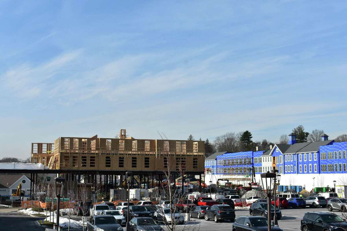 The two main buildings of Darien Crossing under construction in mid-January 2022 in Darien, Conn., with the development to include as many as two-dozen shops across from the Noroton stop of the Metro North commuter rail line.
