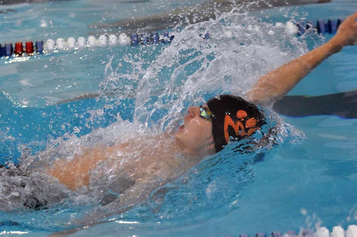 Edwardsville's Eddie Myers competes in the 50-yard backstroke during the Swim for Hope meet inside Chuck Fruit Aquatic Center in Edwardsville.