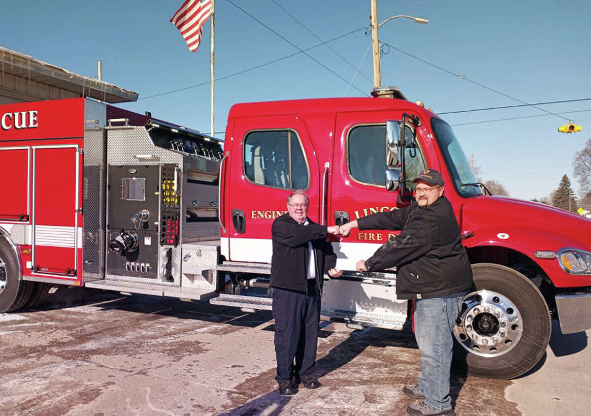 Lincoln Township Fire Chief David Beldon (left) gratefully accepted a payment from Richard Steig of T.C. Energy (right) toward the new fire engine. 