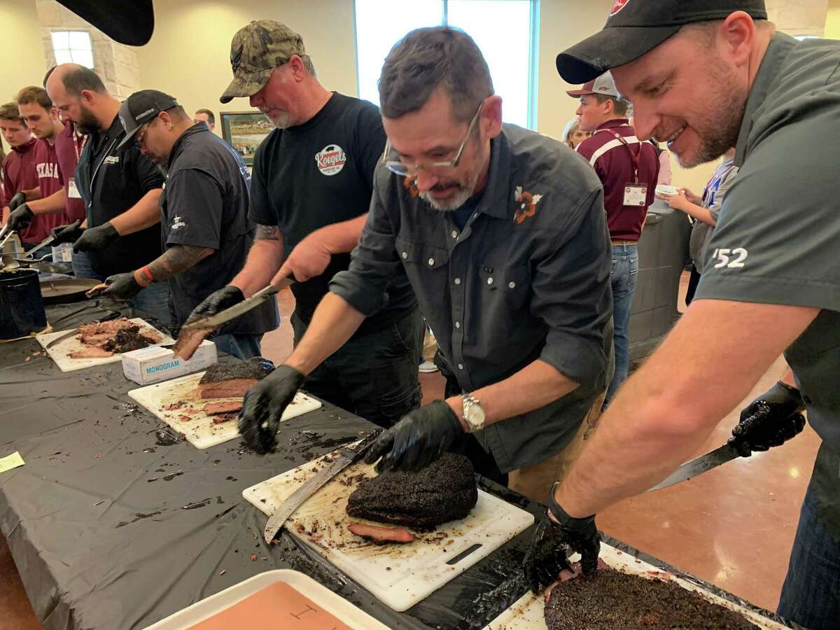 Tuffy Stone, center, the campion pitmaster from Richmond, Va., helped slice and serve brisket at 2022 Camp Brisket. He's flanked by Russell Roegels, pitmaster/owner of Roegels Barbecue Co. in Houston, and Jason Pruitt, grilling expert for Weber Grills.