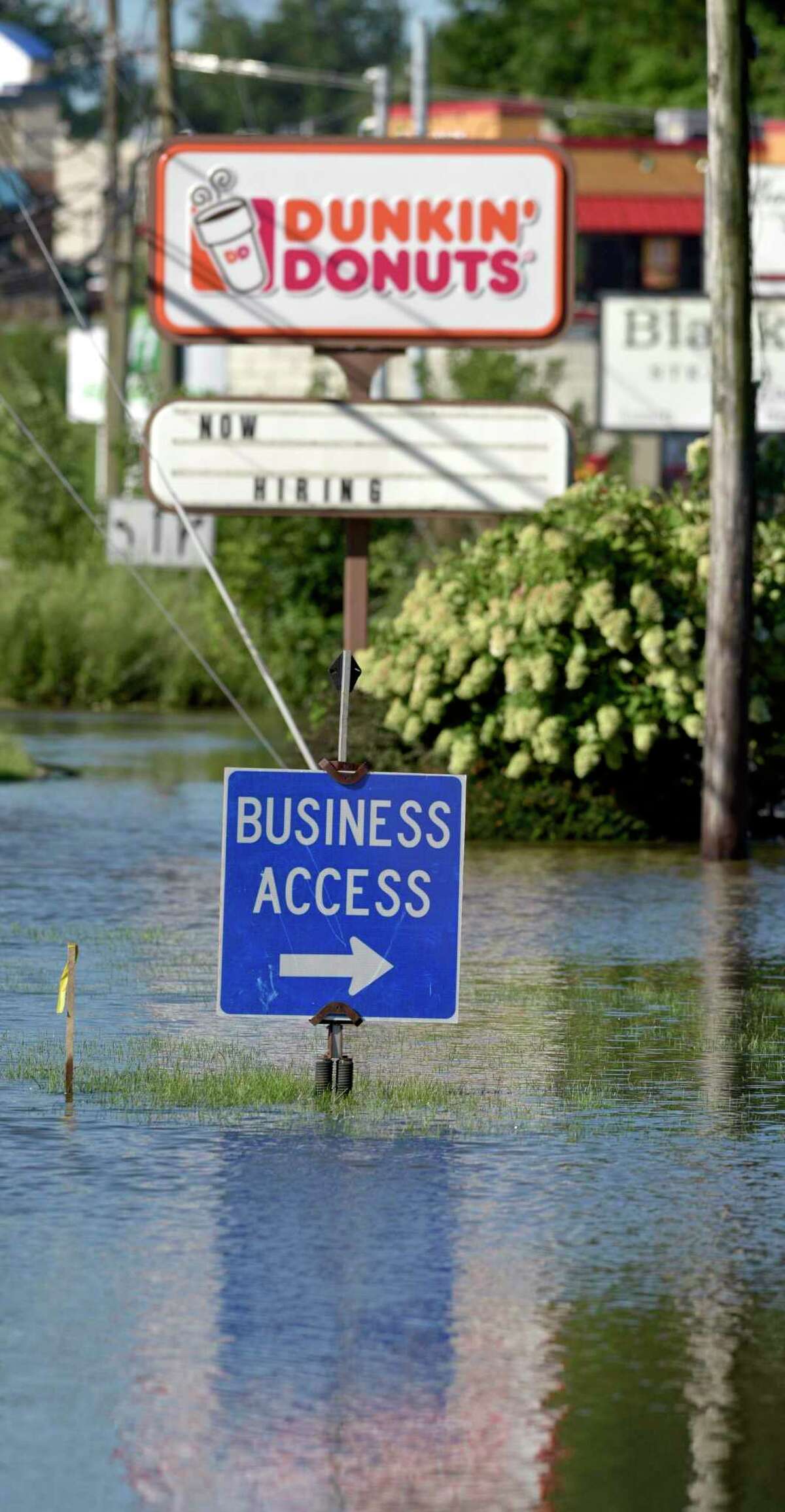 Newtown Road is blocked by overflowing water from Limekiln Brook in Danbury on Sept. 2, 2021. Remnants of hurricane Ida brought heavy rain and winds to Connecticut, and businesses in parts of the state are eligible for federal loans.