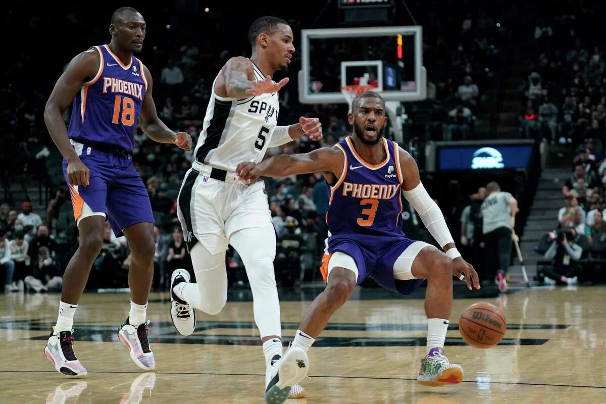 Phoenix Suns guard Chris Paul (3) drives around Spurs guard Dejounte Murray (5) during the second half Monday, Jan. 17, 2022, in San Antonio.