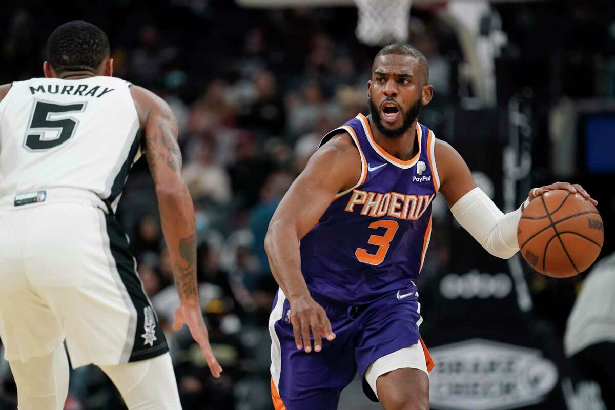 Phoenix Suns guard Chris Paul (3) is guarded by Spurs guard Dejounte Murray (5) during the second half Monday, Jan. 17, 2022, in San Antonio.