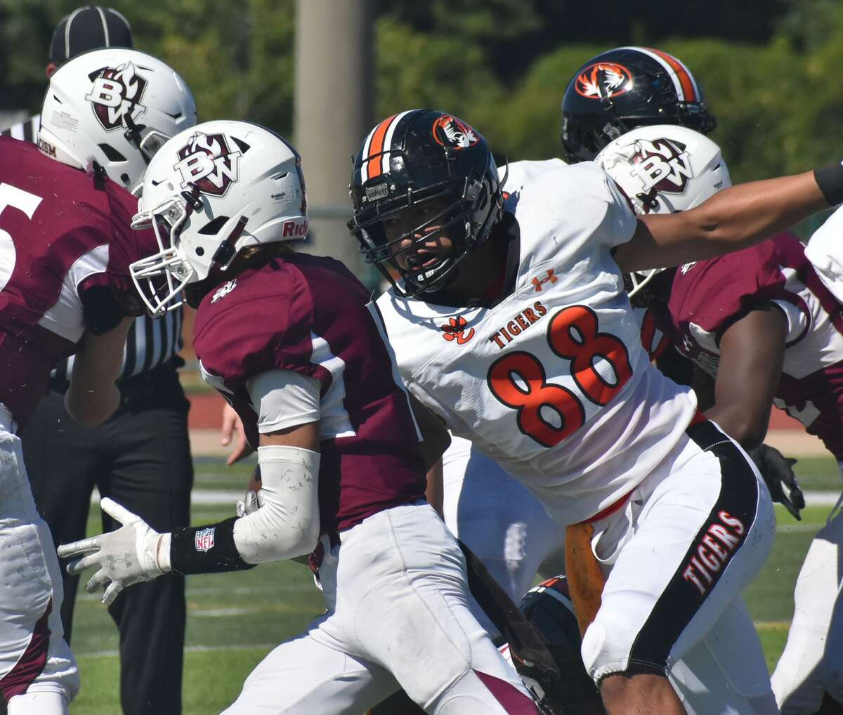 Edwardsville defensive end Iose Epenesa prepares to bring down the Belleville West ball carrier in the backfield during a game in the 2021 season.