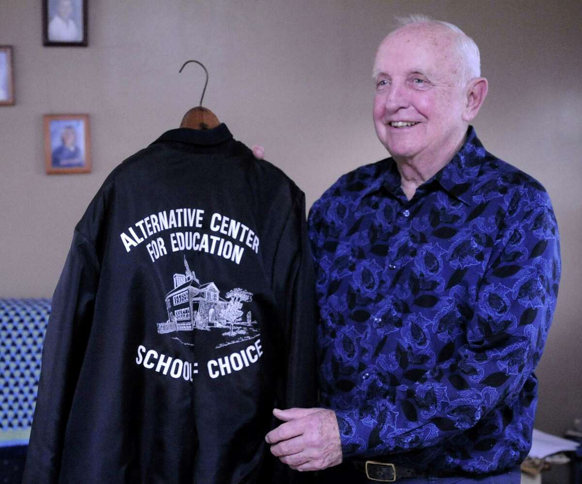 Joe Pepin holds his jacket from the Alternative Center for Excellence, the Danbury school where he was the first principal and remained for 20 years. Photographed in his Danbury home Friday, Feb. 17, 2012. Pepin died at 85 in January 2022. ACE plans to hold a celebration honoring him for his birthday.