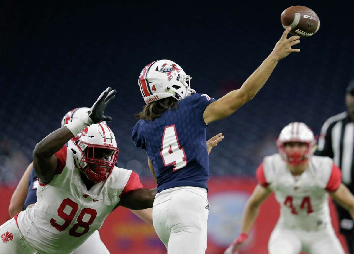 Katy Tigers Moro Ojomo (98) pressures Atascocita Eagles quarterback Jack Roe (4) in the first half during the high school football playoff game between the Atascocita Eagles and the Katy Tigers at NRG Stadium in Houston, TX on Saturday, December 1, 2017.