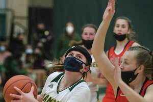 Hamden’s Gianna Donnarummo drives to the basket defended by Sacred Heart Academy’s Meghan Kirck on Jan. 6.