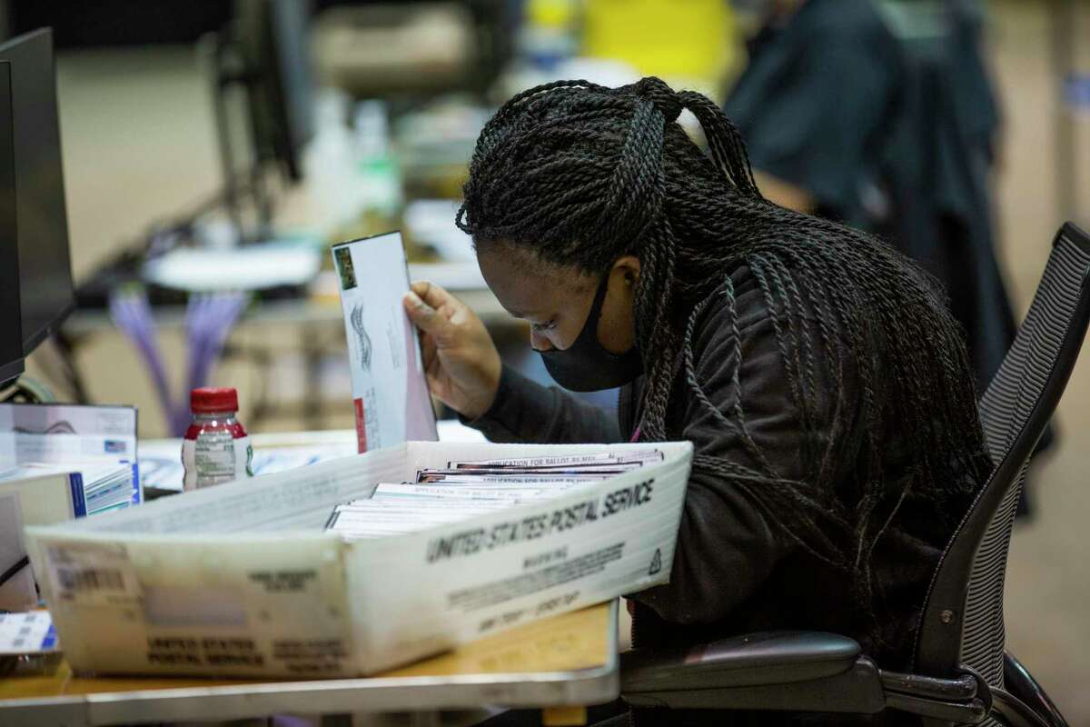 A Harris County worker sorts mail-in ballots applications at the Harris County Clerk’s election headquarters at the NRG Arena on Friday, Sept. 25, 2020, in Houston.