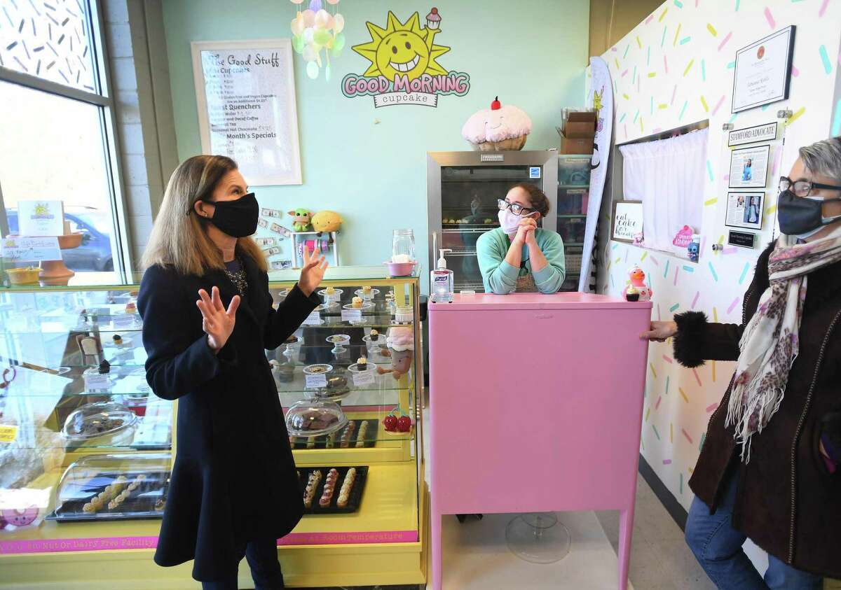 From left, Lt. Governor Susan Bysiewicz chats with business owner Adrianna Robles and Women's Business Development Council President and CEO Fran Pastore at Robles' Good Morning Cupcake on Melba Street in Miford, Conn. on Thursday, February 4, 2021. Robles received a business grant as part of the group's Equity Match Grant program.