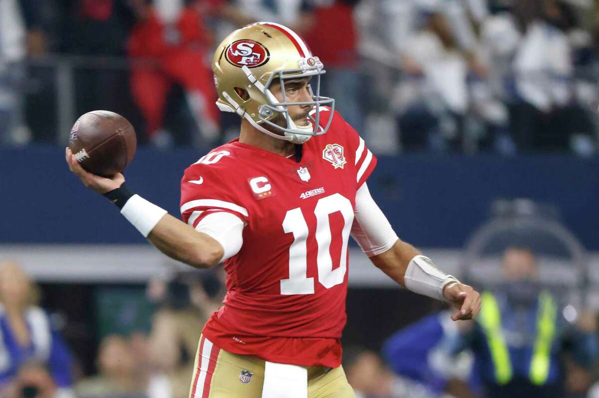 San Francisco 49ers quarterback Jimmy Garoppolo (10) passes against the Dallas Cowboys during the first half of an NFL wild-card playoff football game in Arlington, Texas, Sunday, Jan. 16, 2022. (AP Photo/Ron Jenkins)