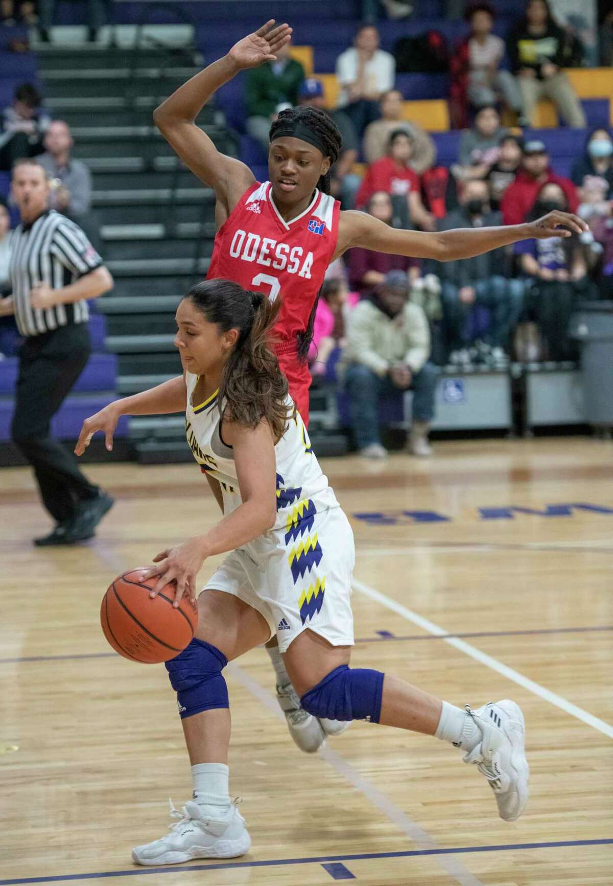Midland High's Noemi Arciga drives to the basket as Odessa High's Donajah Watkins leaps too early to block 01/18/2022 at the Midland High gym. Tim Fischer/Reporter-Telegram