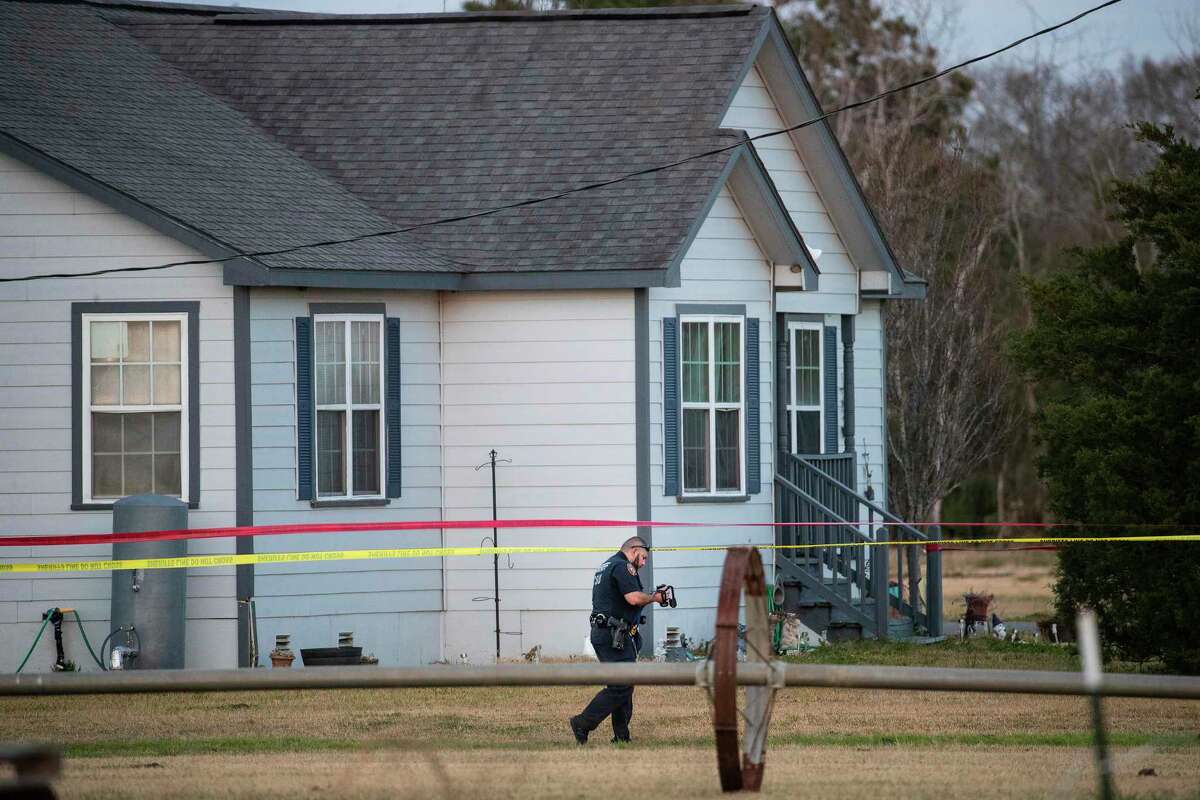A crime scene investigator works the scene where the bodies of three teenagers were found dead inside of a home Tuesday, Jan. 18, 2022 in Crosby. Sherff Ed Gonzalez said that there were two female and one male victim in an apparent murder, suicide.