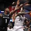 Connecticut's Adama Sanogo (21) shoots as Butler's Bo Hodges (1) defends during the first half of an NCAA college basketball game Tuesday, Jan. 18, 2022, in Hartford, Conn. (AP Photo/Jessica Hill)