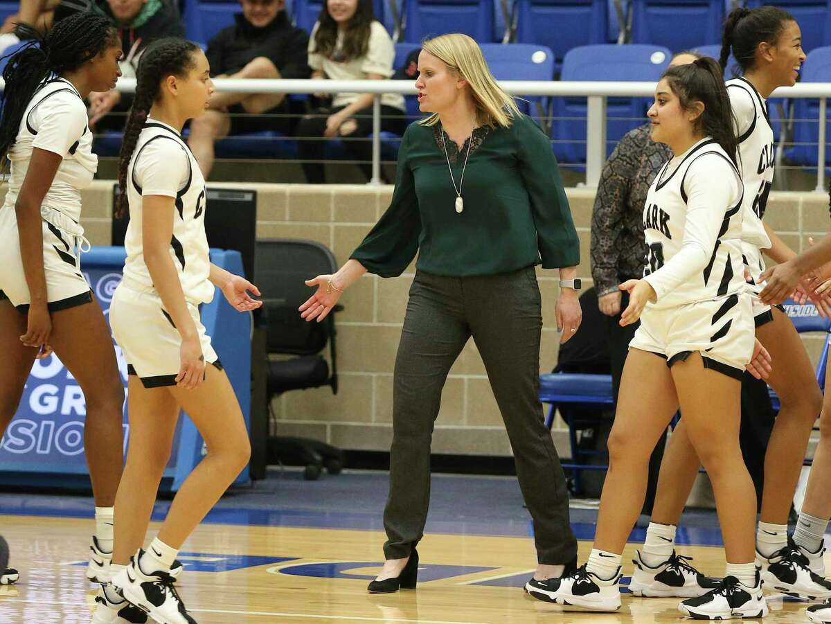 Clark coach Rihana Houy (center) congratulates her players during a timeout against Brandeis during girls basketball at Northside Sports Gym on Tuesday, Jan. 18, 2022.
