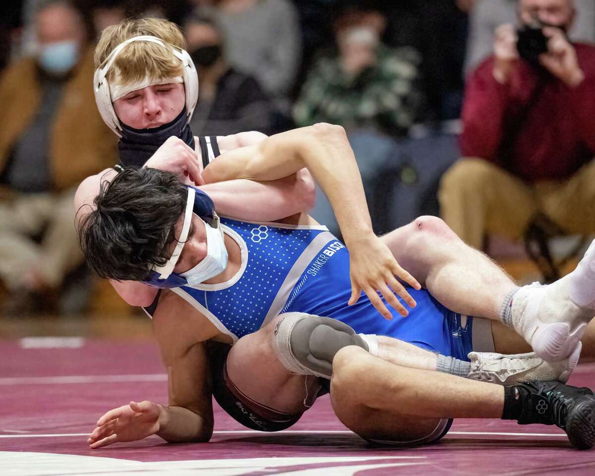 Burnt Hills' Gabriel Goss, top, wrestles Shaker's Sameer Abbaszadeh in the 132-pound weight class at the Section II Division I Dual championship at Burnt Hills High School on Tuesday.