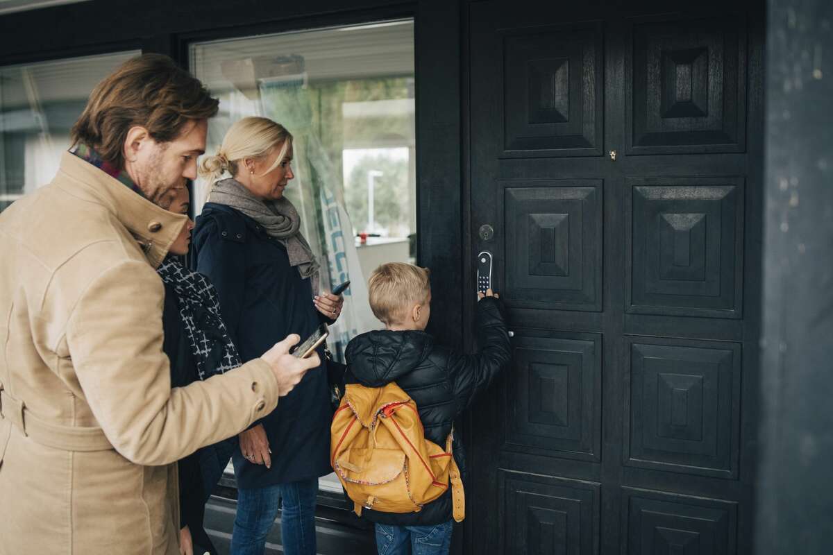A child enters his family's security code to enter their home. 