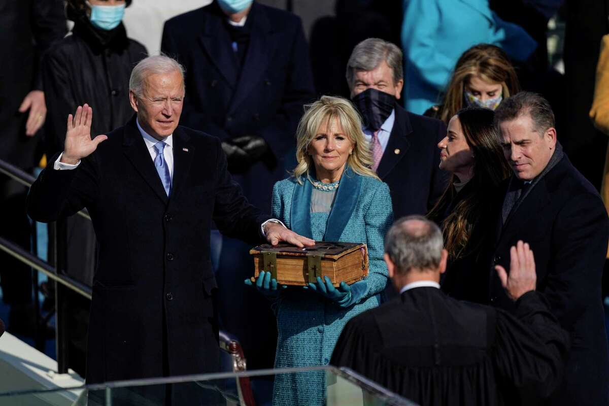 President Joe Biden takes the oath of office from Supreme Court Chief Justice John Roberts as his wife, Jill Biden, stands next to him during the 59th presidential inauguration in Washington, D.C., on Jan. 20, 2021. (Kent Nishimura/Los Angeles Times/TNS)
