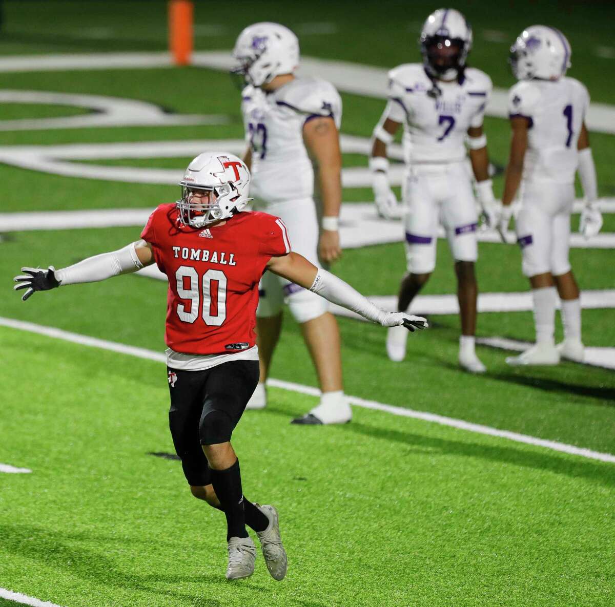 Tomball defensive linemen Cavan Tuley (90) celebrates after recovering a fumble by Willis running back Da'Ontae Fleeks for a 12-yard touchdown during the third quarter of a Region II-6A (Div. II) area football game at Planet Ford Stadium, Friday, Nov. 19, 2021, in Spring.