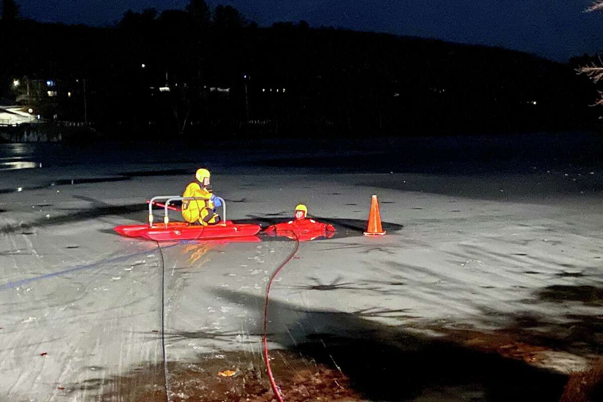 Firefighters train on cold-water rescues at the Higganum Reservoir in Haddam, Conn., on Monday, Jan. 17, 2022.