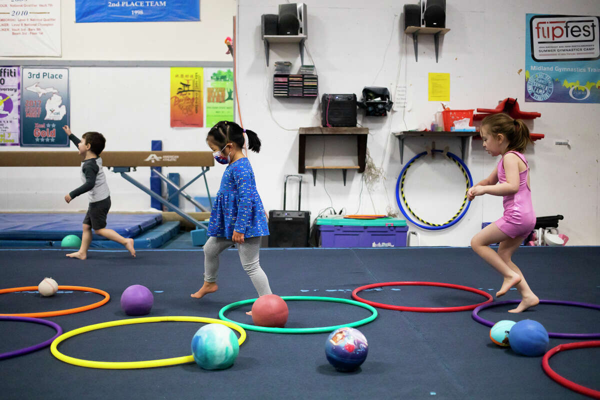 From left, William Schefsky, 3, Jun Rui Koh, 3, and Avery Hospodar, 4, play together Wednesday, Jan. 19, 2022 during a weekly preschool recess session at Midland Gymnastics Training Center.