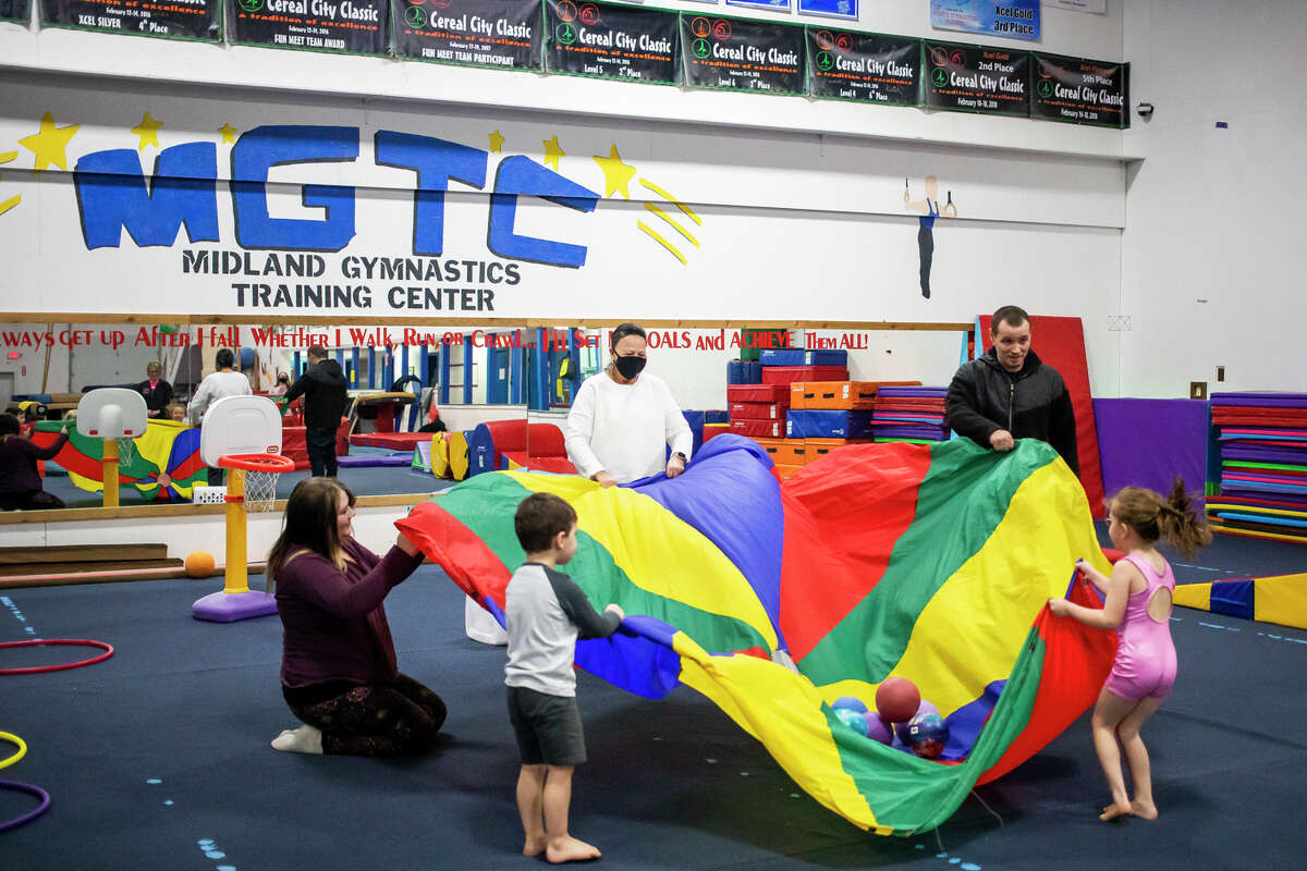 Children play together and explore gym equipment on Wednesday, January 19, 2022 during a weekly preschool play session at Midland Gymnastics Training Center.
