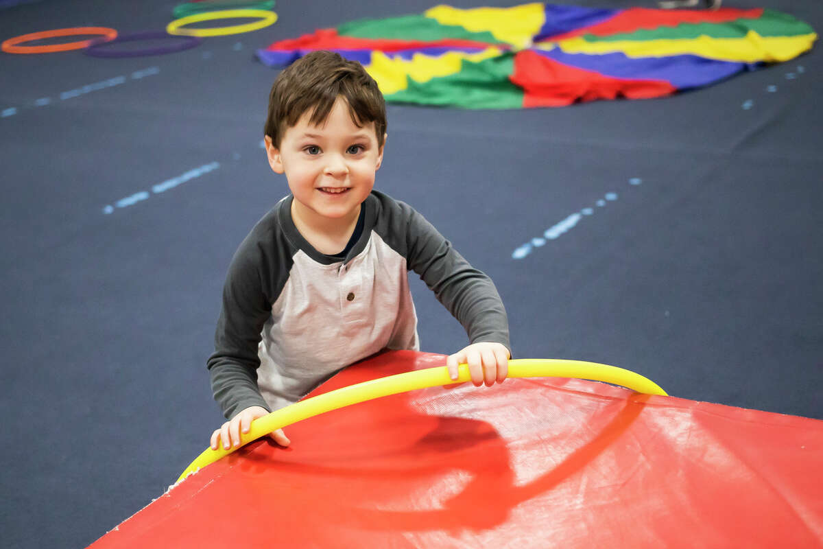 William Schefsky, 3, plays with a hoop Wednesday, Jan. 19, 2022 during a weekly preschool play session at Midland Gymnastics Training Center.