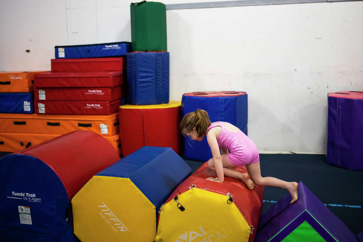 Avery Hospodar, 4, climbs hurdles while playing Wednesday, Jan. 19, 2022 during a weekly preschool play session at Midland Gymnastics Training Center.