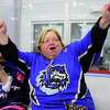 Sound Tigers Booster Club President, Debbie Lietuvninkas, cheers after a goal is scored by a player in the Southern Connecticut Storm, a special needs ice hockey program, during a hockey clinic held in conjunction with Bridgeport Police Department's ice hockey team at the Wonderland of Ice in Bridgeport, Conn. on Thursday March 20, 2014. The Sound Tiger's team captain, Chris Bruton, was also at the clinic helping the kids and a few older players, with their hockey skills.