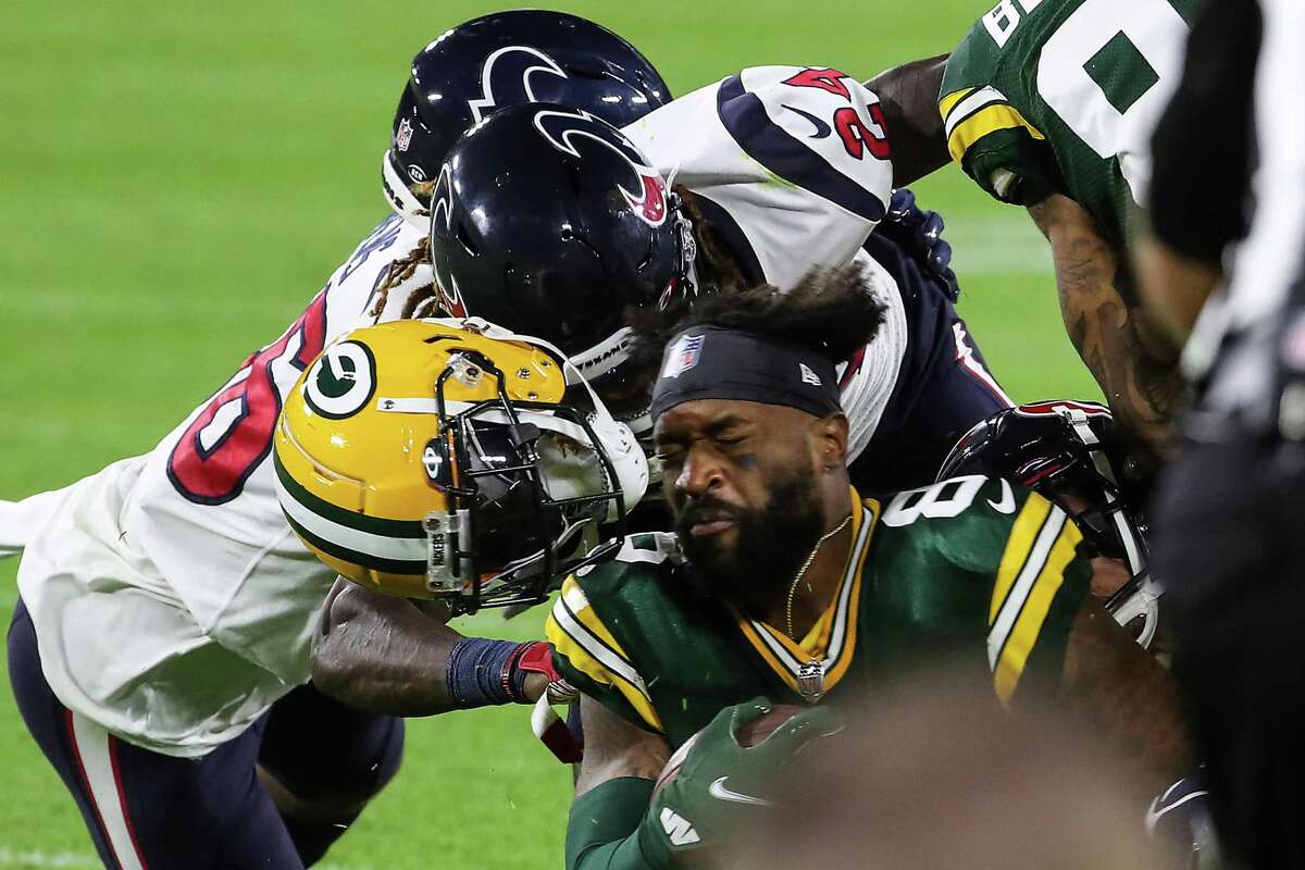 Green Bay Packers wide receiver Amari Rodgers (8) loses his helmet as he is hit by Houston Texans defensive back Tremon Smith (24) during the second half of an NFL pre-season football game Saturday, Aug. 14, 2021, in Green Bay, Wis.