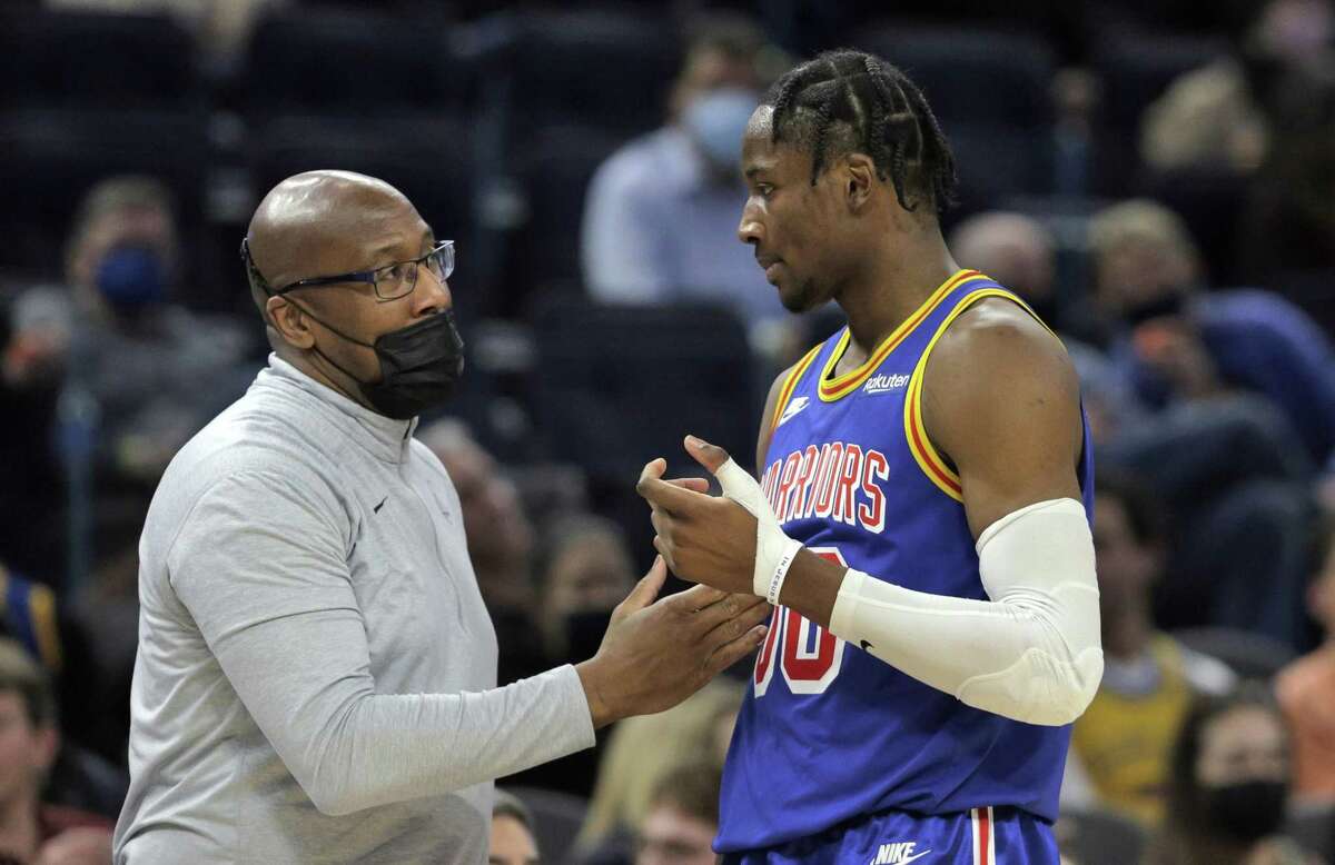 Jonathan Kuminga (00) talks with coach Mike Brown in the second half as the Golden State Warriors played the Detroit Pistons at Chase Center in San Francisco, Calif., on Tuesday, January 18, 2022.