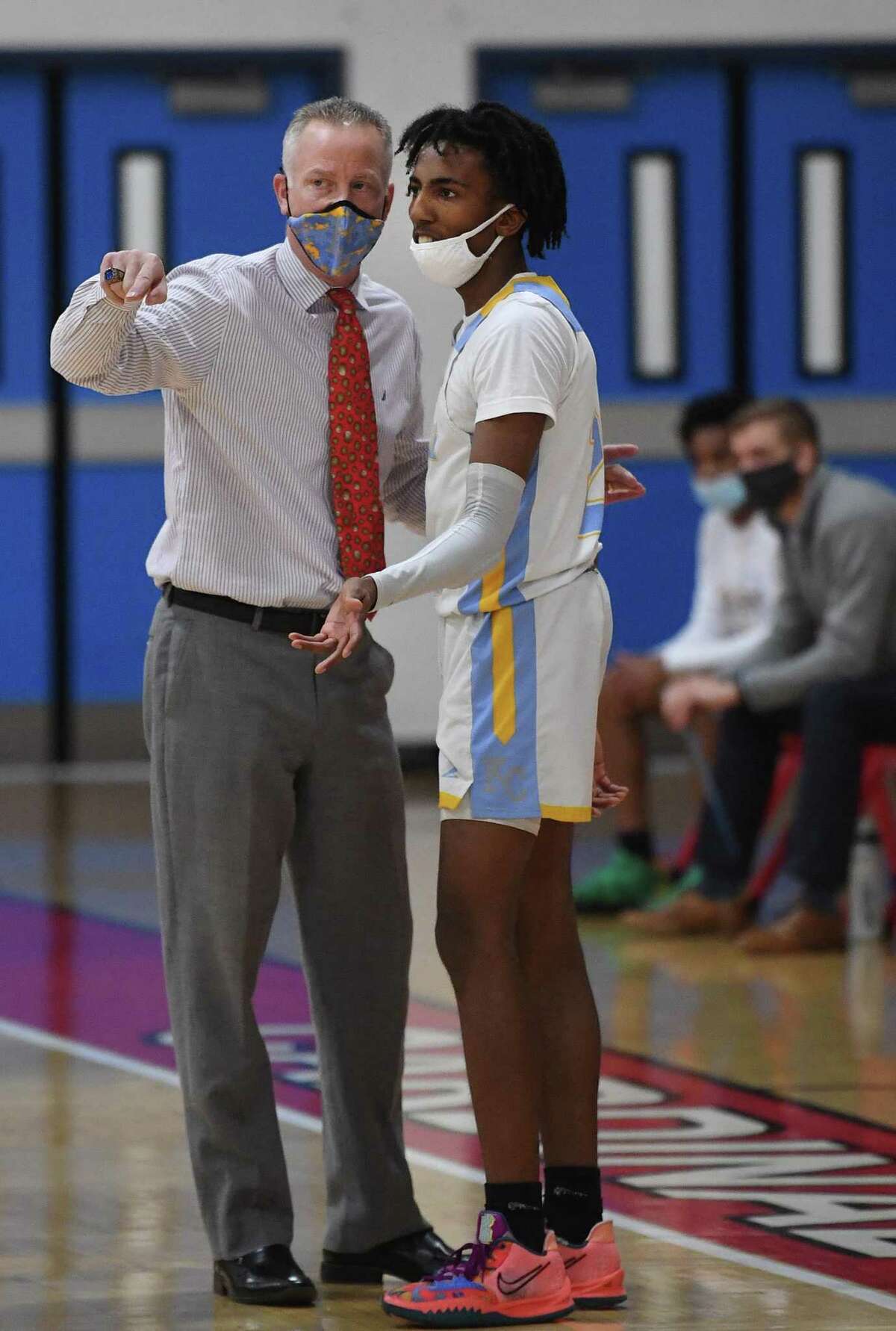 Kolbe Cathedral Coach John Pfohl strategizes with star guard Tyrell Staples-Santos during a basketball game against Bunnell at the Sheehan Center in Bridgeport on Tuesday.
